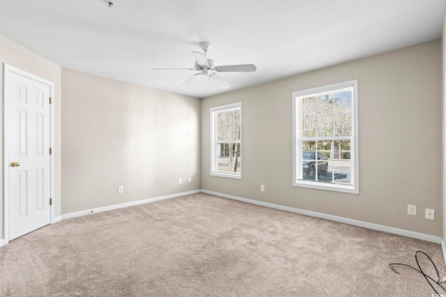 empty room featuring carpet floors, ceiling fan, and baseboards