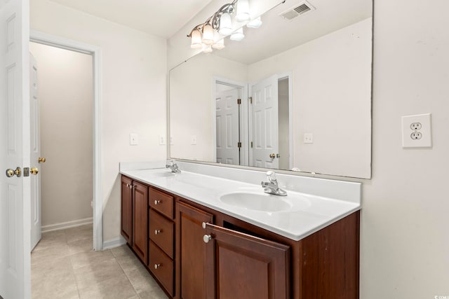 bathroom with double vanity, tile patterned flooring, a sink, and visible vents