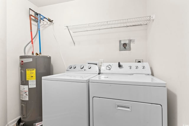 washroom with laundry area, independent washer and dryer, and electric water heater