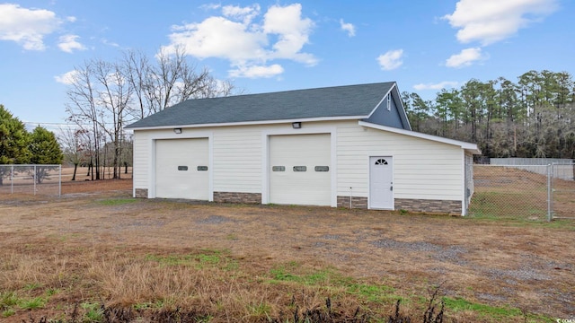 detached garage featuring fence