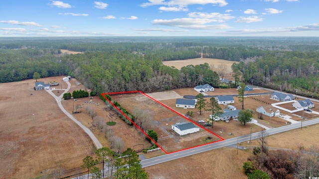 birds eye view of property with a forest view