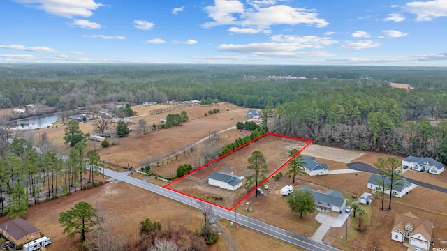 aerial view featuring a water view and a view of trees