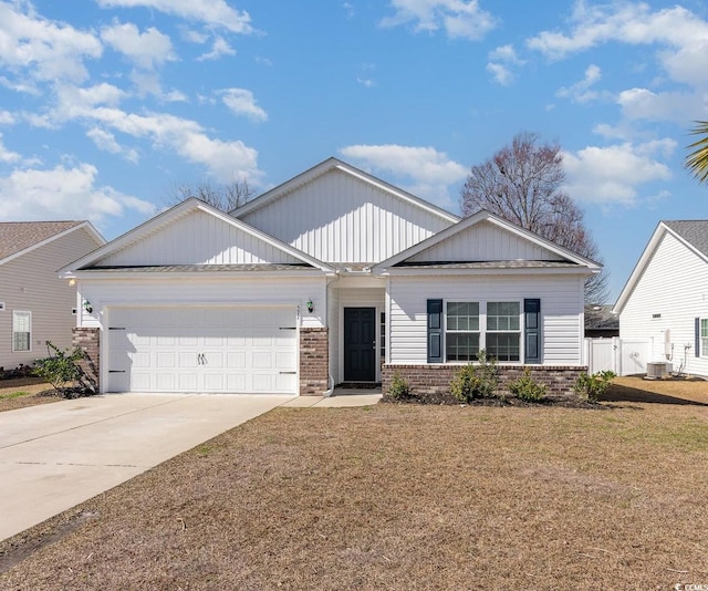 view of front of home featuring driveway, brick siding, an attached garage, and central air condition unit