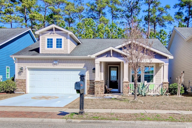 craftsman-style house featuring a garage, stone siding, roof with shingles, and driveway