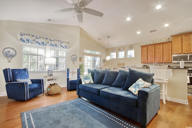 living area featuring light wood-style floors, recessed lighting, visible vents, and baseboards