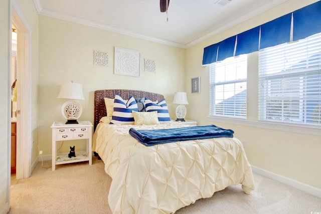 bedroom with a ceiling fan, carpet flooring, crown molding, and baseboards