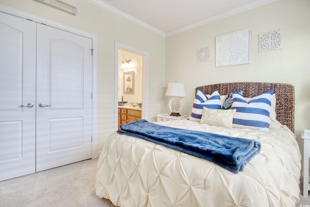 bedroom with crown molding, a closet, ensuite bath, and light colored carpet