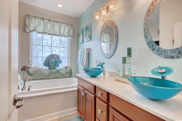 full bathroom featuring double vanity, a sink, and a bath