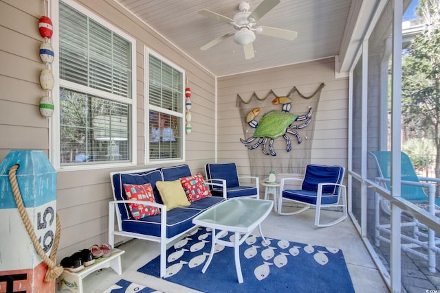 sunroom / solarium featuring a ceiling fan