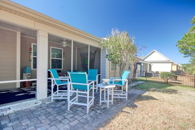 view of patio with fence, outdoor dining area, and a ceiling fan