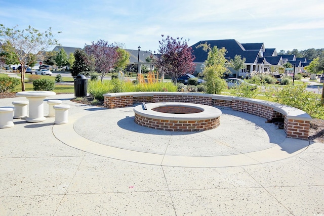 surrounding community with a residential view and an outdoor fire pit