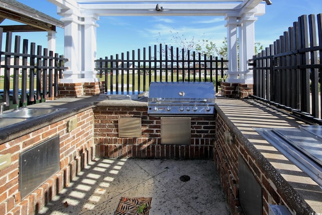 view of patio / terrace featuring area for grilling, an outdoor kitchen, and fence