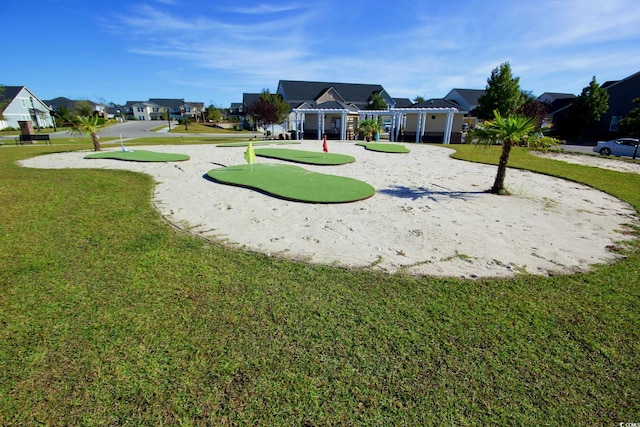 view of property's community with a yard, a residential view, and a pergola