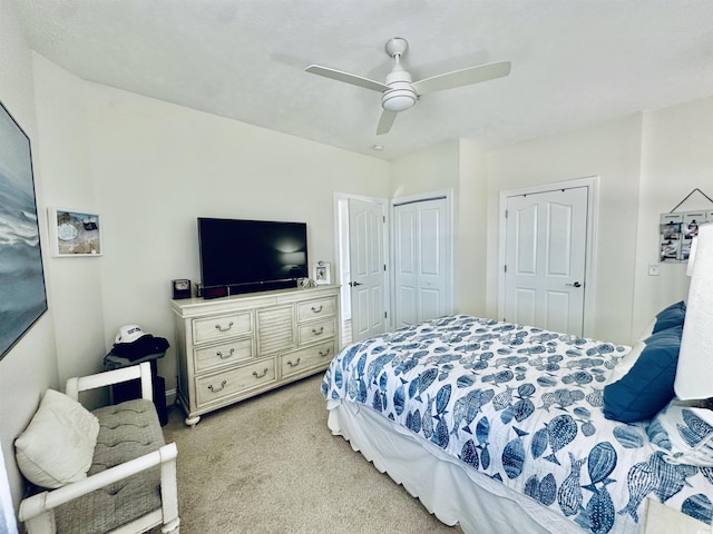 bedroom with light carpet, a closet, and a ceiling fan