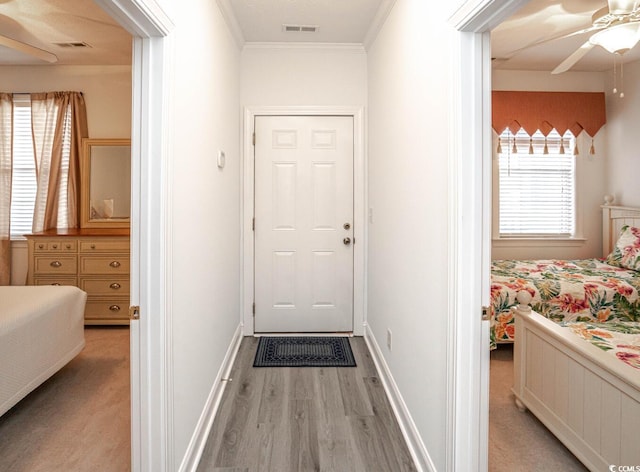 interior space with light wood-type flooring, visible vents, and a healthy amount of sunlight