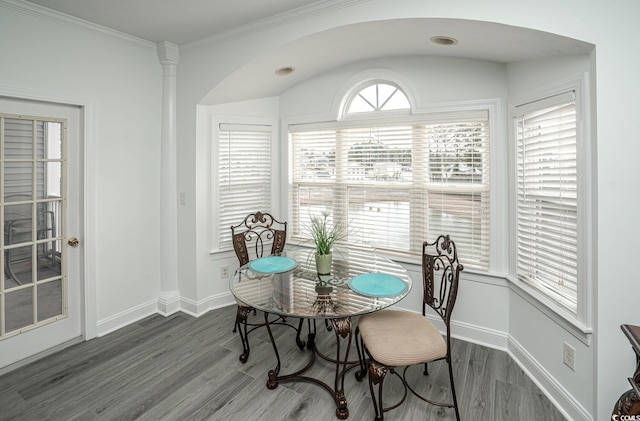 dining area featuring ornamental molding, wood finished floors, and baseboards