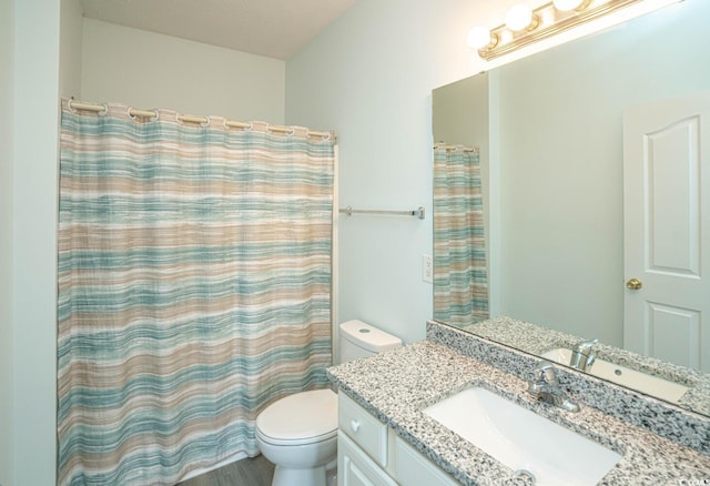 full bathroom featuring curtained shower, vanity, and toilet