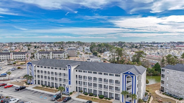 birds eye view of property featuring a city view and a water view