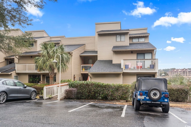 view of property featuring uncovered parking