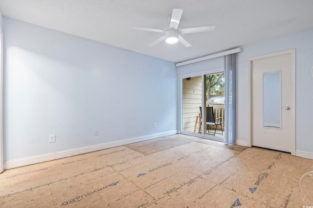 unfurnished room featuring ceiling fan and baseboards