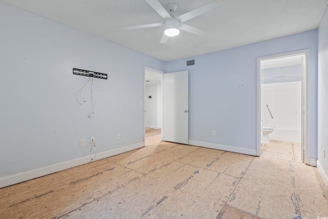 unfurnished bedroom with visible vents, a textured ceiling, baseboards, and ensuite bathroom