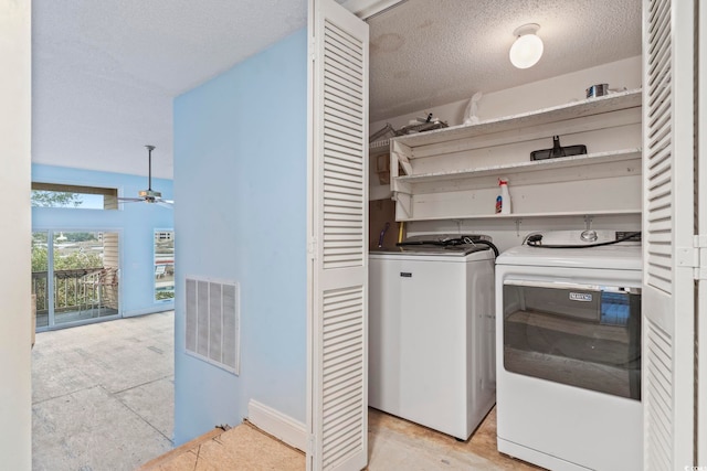 laundry area featuring washing machine and clothes dryer, visible vents, a ceiling fan, a textured ceiling, and laundry area