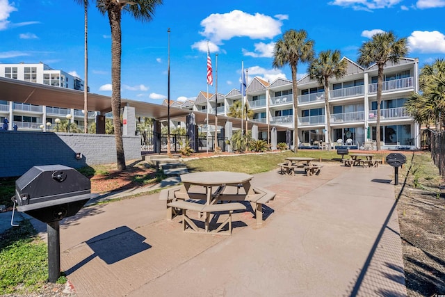 surrounding community with fence and a patio