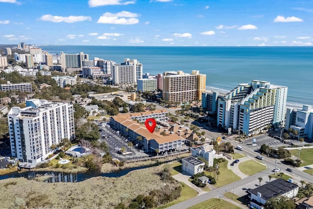 drone / aerial view featuring a view of city and a water view