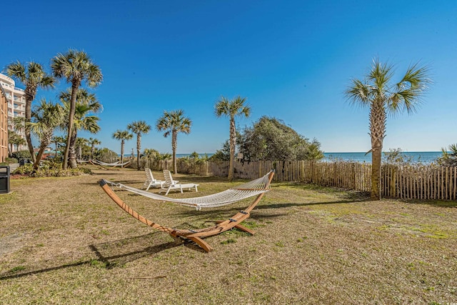 view of yard featuring a water view and fence