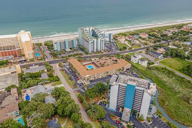 bird's eye view with a water view and a beach view