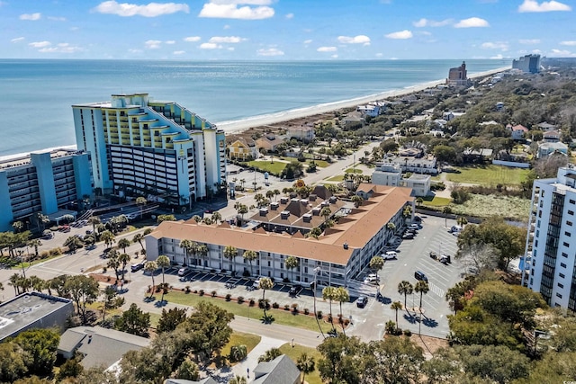 birds eye view of property featuring a beach view and a water view