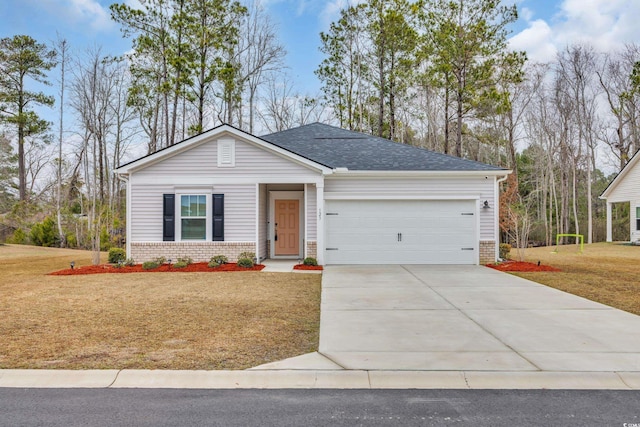 view of front of house featuring a front yard, brick siding, driveway, and an attached garage