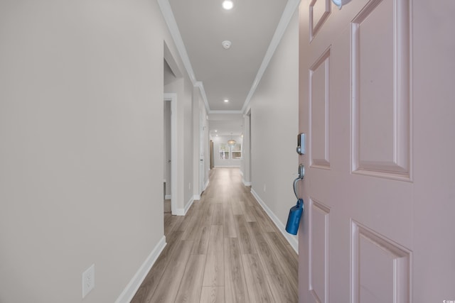 corridor featuring ornamental molding, light wood-type flooring, recessed lighting, and baseboards