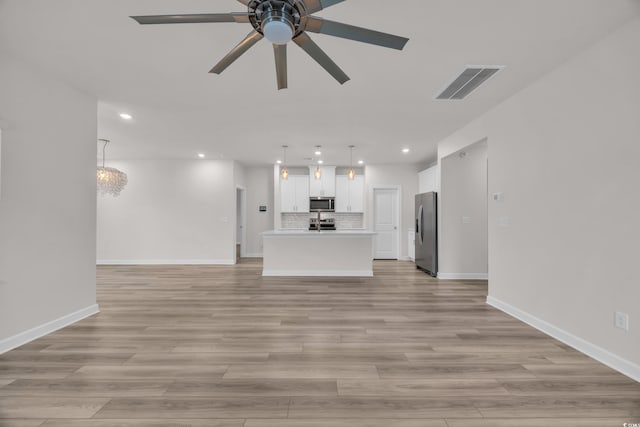 unfurnished living room featuring recessed lighting, a ceiling fan, baseboards, light wood-style floors, and visible vents