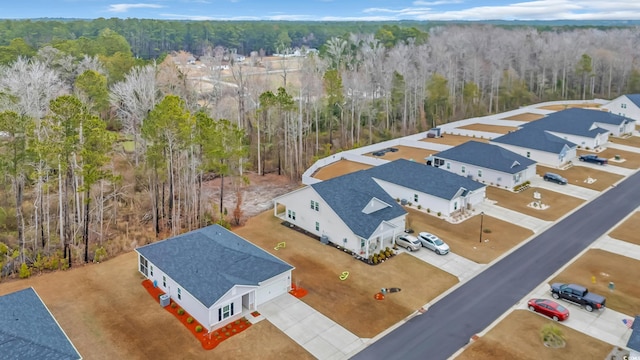 birds eye view of property featuring a view of trees