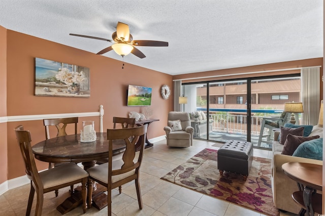 dining space with light tile patterned floors, baseboards, a textured ceiling, and ceiling fan