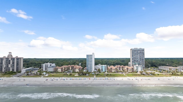 drone / aerial view featuring a view of city, a view of the beach, and a water view