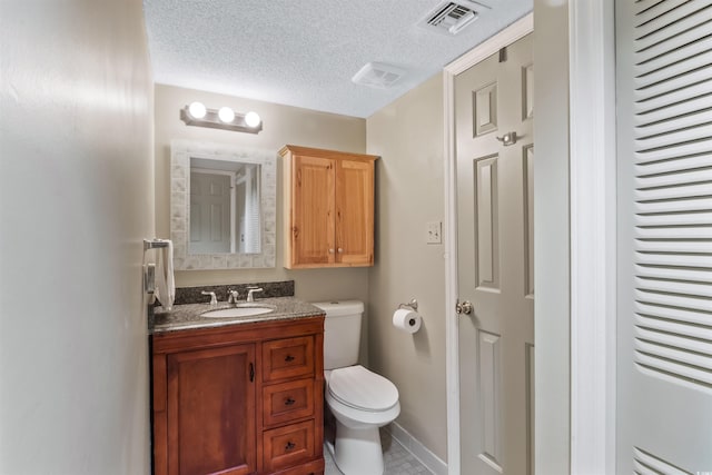 bathroom featuring visible vents, a textured ceiling, toilet, and vanity