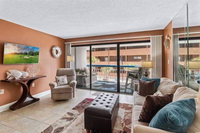 living room with tile patterned flooring, baseboards, and a textured ceiling