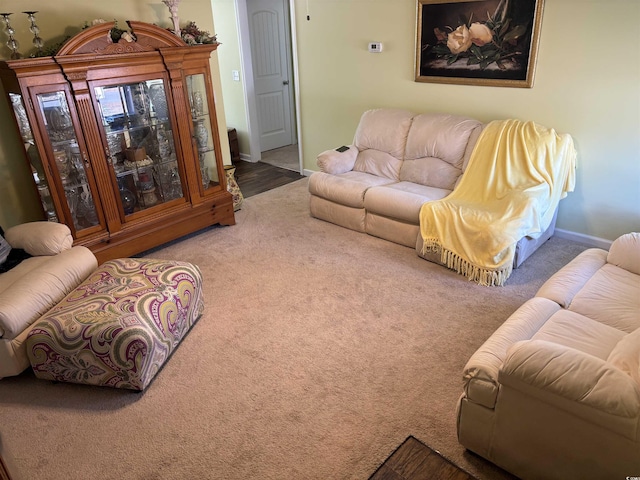 carpeted living room with baseboards