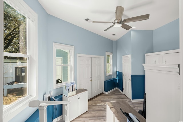 interior space with light wood-style floors, visible vents, and ceiling fan