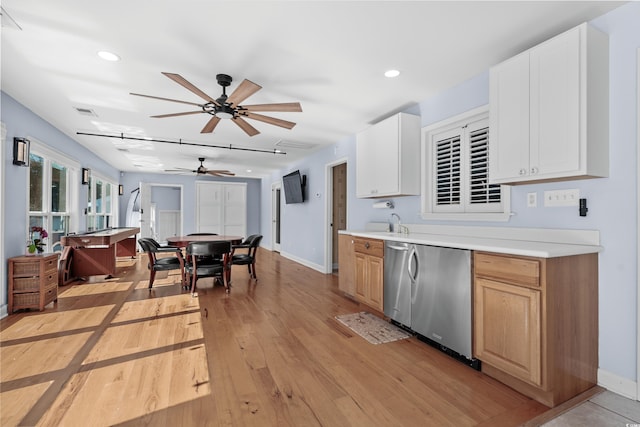 kitchen featuring white cabinetry, light countertops, fridge, light brown cabinetry, and light wood finished floors