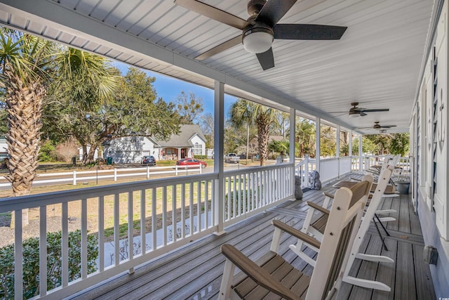 wooden terrace with a porch and a ceiling fan