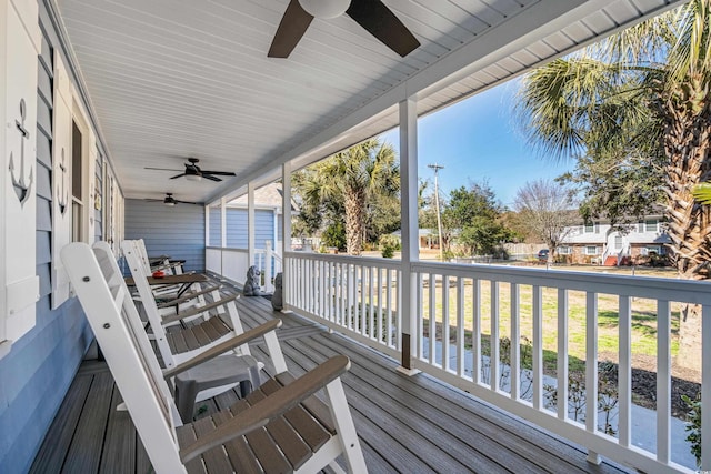 wooden deck with a porch and a ceiling fan