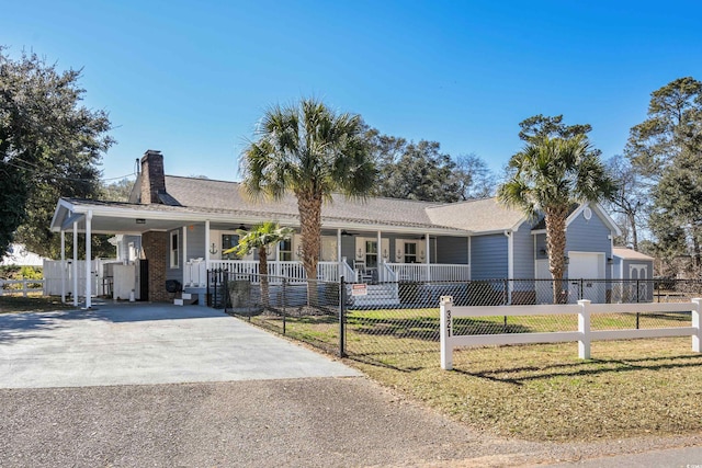 ranch-style house featuring covered porch, driveway, a front lawn, and a fenced front yard