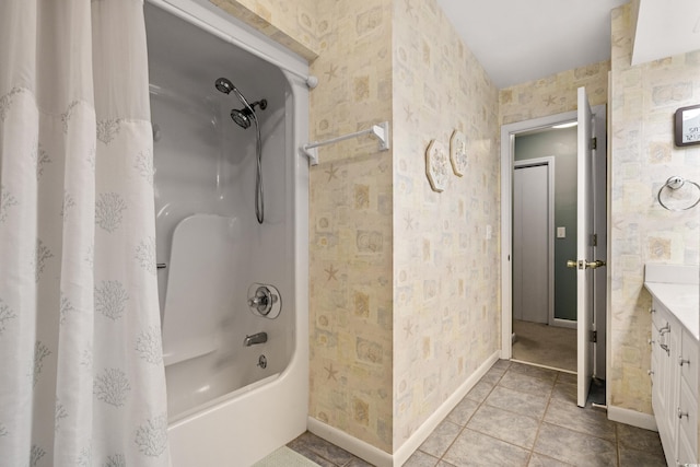 full bath with shower / tub combo, vanity, baseboards, and wallpapered walls