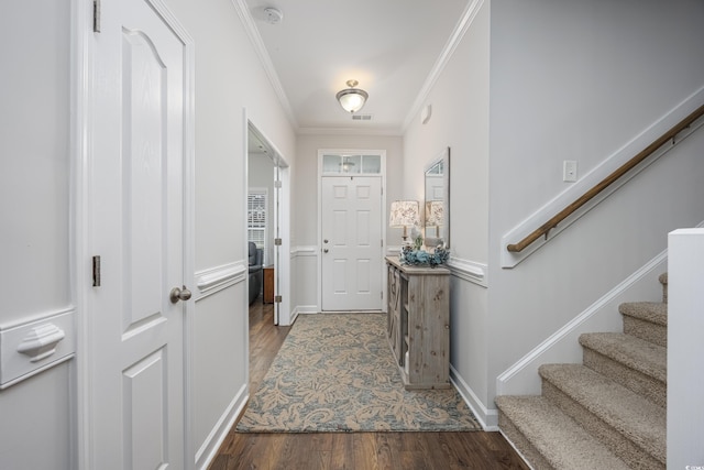 entryway featuring ornamental molding, visible vents, stairs, and wood finished floors