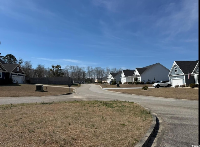 view of street with a residential view and curbs