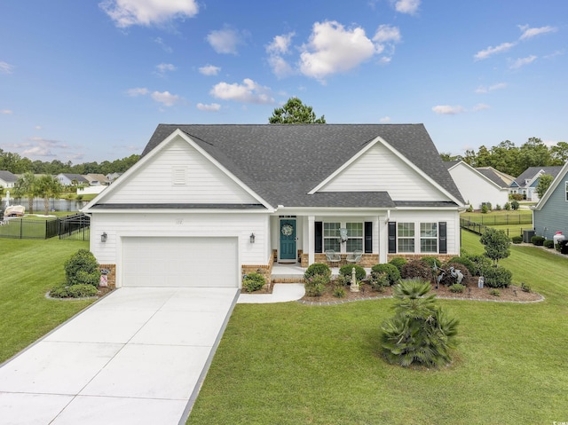 view of front of property featuring a front yard, driveway, and fence