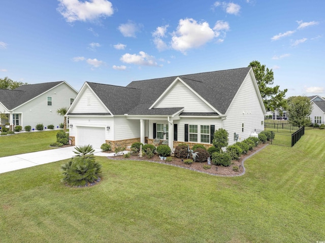 view of front of home with roof with shingles, concrete driveway, fence, a garage, and a front lawn